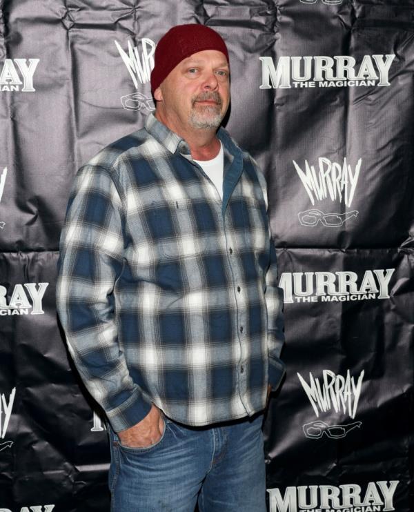 Rick Harrison in red beanie and plaid shirt attending Murray SawChuck's 50th birthday party at Rick's Tavern in Las Vegas.